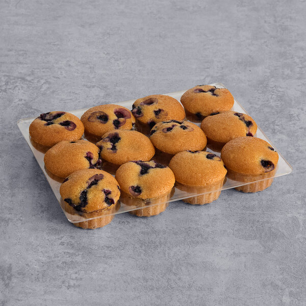 A tray of Abe's Vegan Wild Blueberry mini muffins on a gray surface.