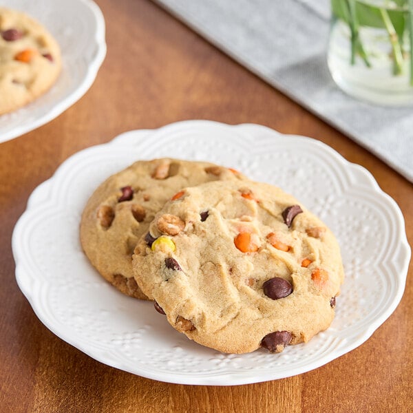 Two David's Cookies peanut butter chocolate chip cookies on a white plate.