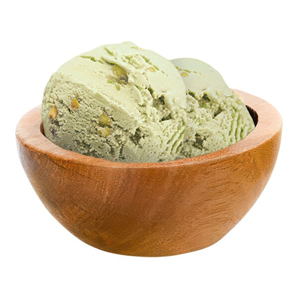 A bowl of pistachio gelato with a scoop on top.