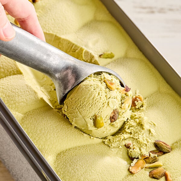A scoop of G.S. Gelato Italiano Pistachio Gelato in a container.