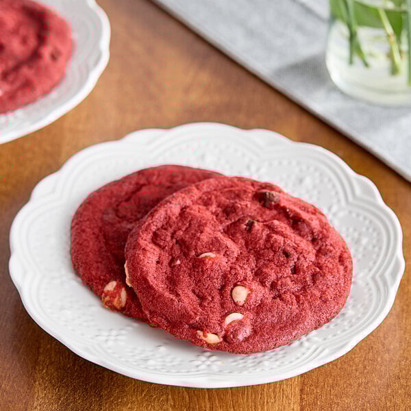A white plate of red David's Cookies red velvet cookies.