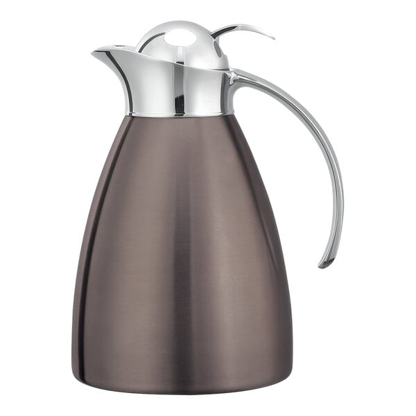 A stainless steel Service Ideas Marquette coffee carafe with a handle and push button lid.