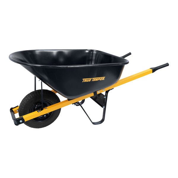 A black wheelbarrow with yellow handles.