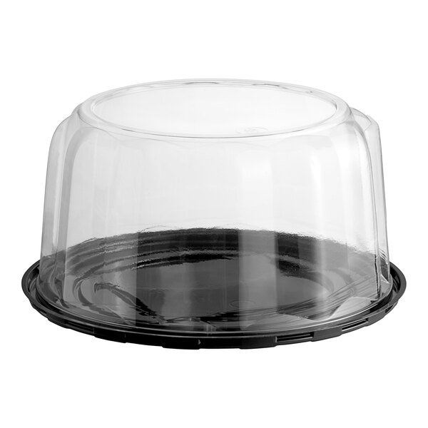 A clear plastic Baker's Lane cake display container with a clear scalloped dome lid.