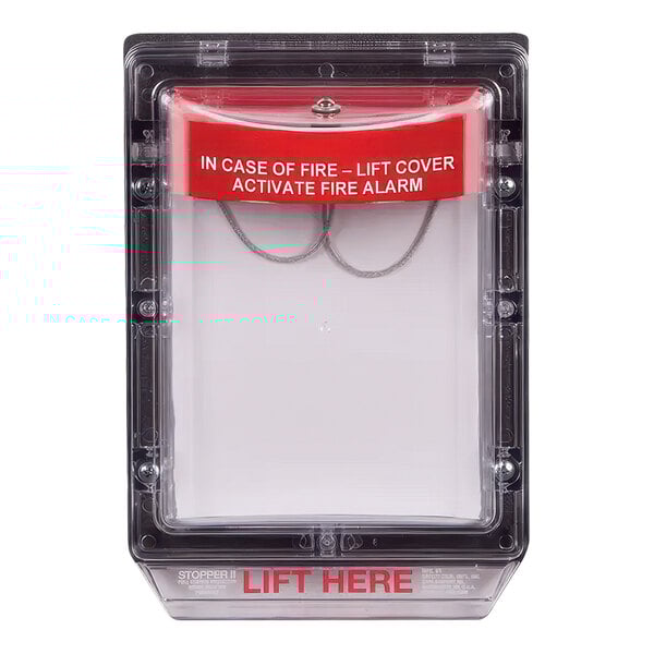 A clear box with a white cover and red label with the words "lift here" over a fire alarm.