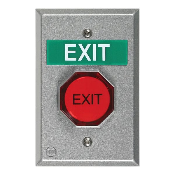 A red pneumatic universal button with black text next to a green sign on a silver wall.