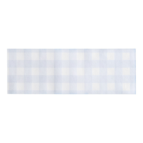 A blue and white checkered paper napkin band with a white square on a blue fabric.