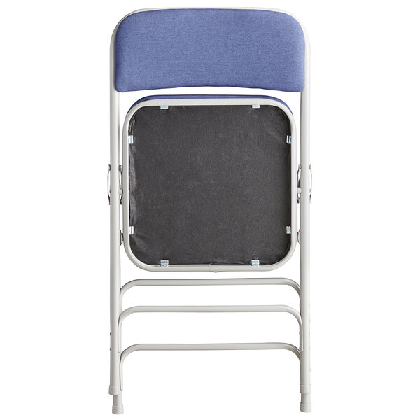 A back view of a blue Lancaster Table & Seating folding chair with a black padded seat.