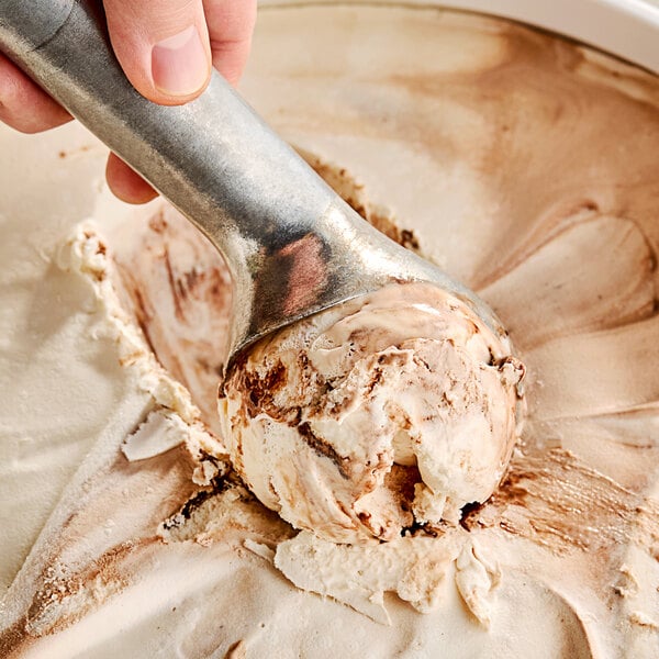 A hand scooping Klein's Real Kosher Vegan Caramel Fudge Ice Cream.