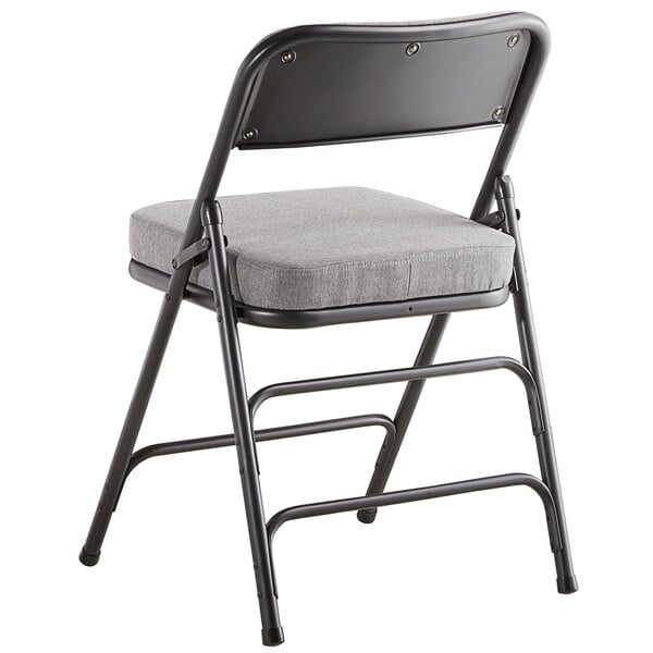 A gray Lancaster Table & Seating folding chair with a gray cushion.