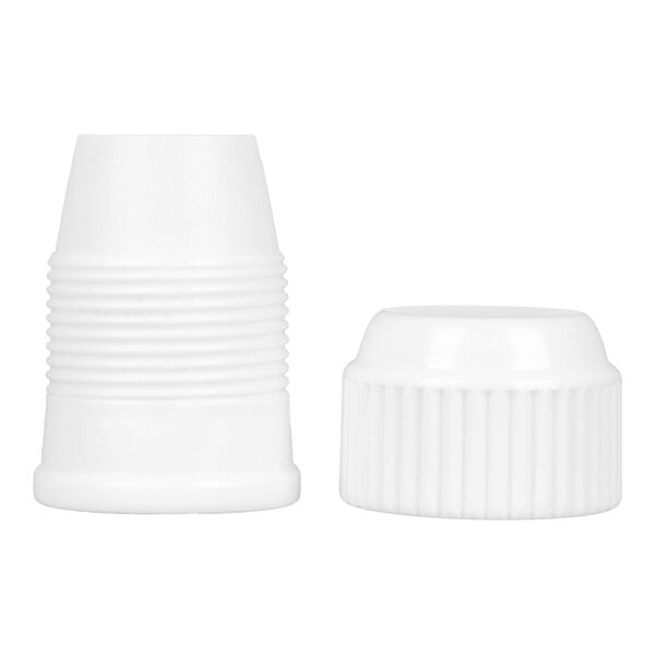 Two white plastic coupler pieces, one upright and one lying on its side, both with ribbed textures.
