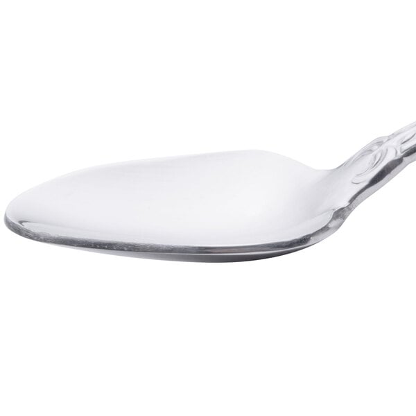 A Oneida Rosewood stainless steel demitasse spoon with a silver handle.