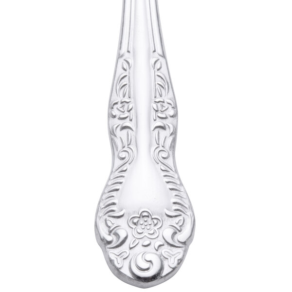 A Oneida Rosewood stainless steel demitasse spoon with a floral design on the handle.