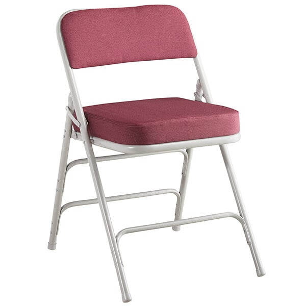 A burgundy Lancaster Table & Seating folding chair with a white frame.