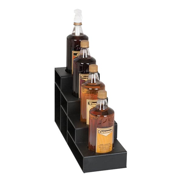 A black Dispense-Rite 4-tier bottle organizer holding bottles of liquid.