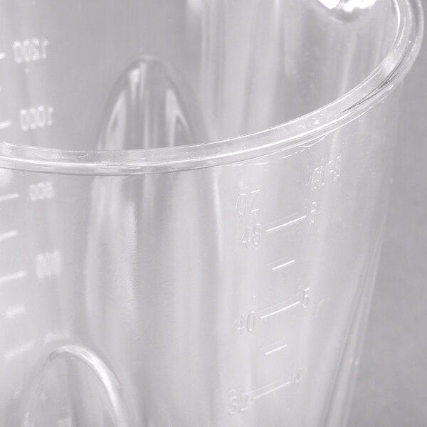 A clear plastic measuring cup on a counter.