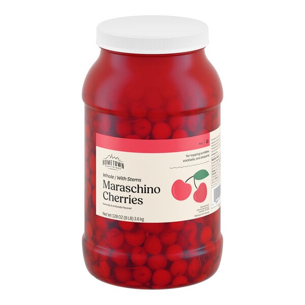 A large plastic jar of Hometown Provisions maraschino cherries with stems.