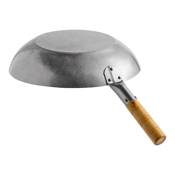 A flat bottom carbon steel wok with a wooden handle.