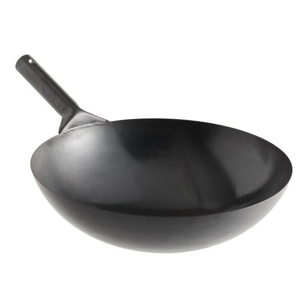 A large black oxidized carbon steel mandarin wok with a single handle.
