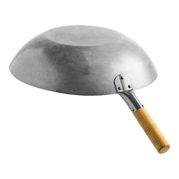 A large flat bottom carbon steel wok with a wooden handle.
