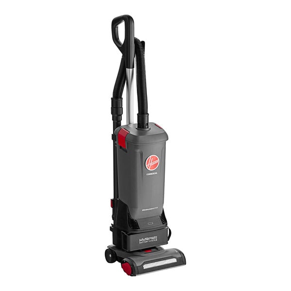 A Hoover HVRPWR cordless upright vacuum cleaner with battery, charger, and cleaning tools.
