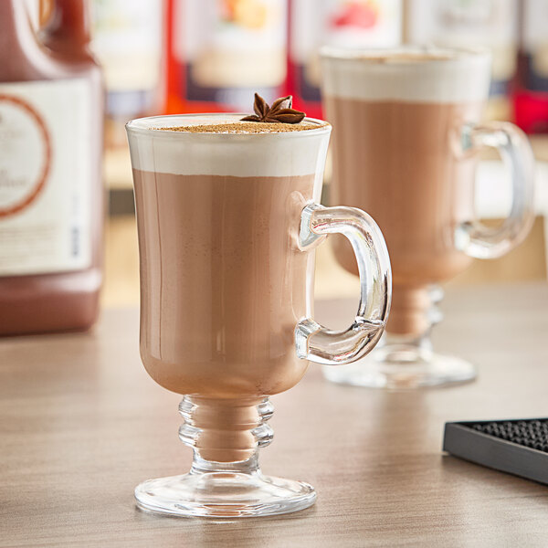 A glass mug of Harney & Sons Chai Tea Latte on a table.