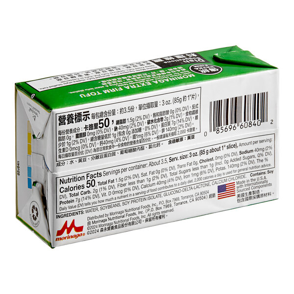 A white and green box of Mori-Nu Silken Extra-Firm Tofu with black text and numbers on it.
