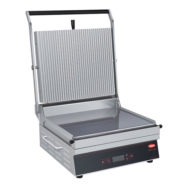 A Hatco Panini Grill with grooved and flat plates on a counter.