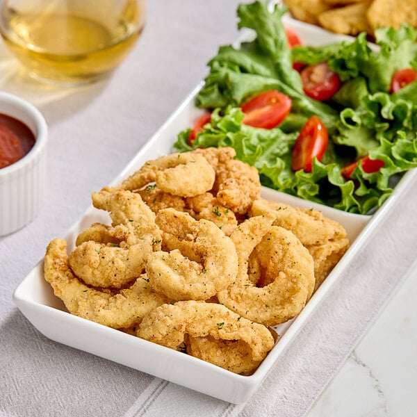Breaded shrimp on a plate with a side of salad.