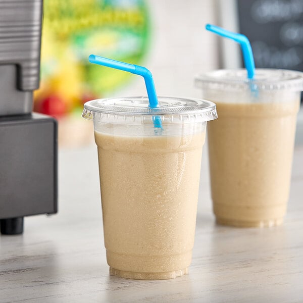 Two cups of Fresh Blends oat shakes with straws.