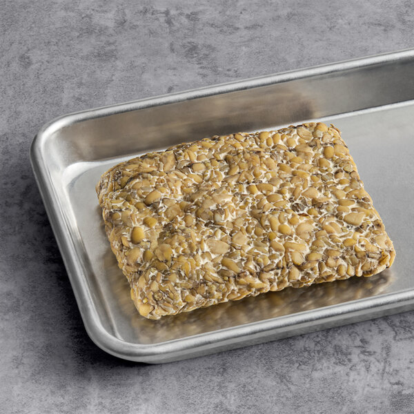 A metal tray with a rectangular object on it.