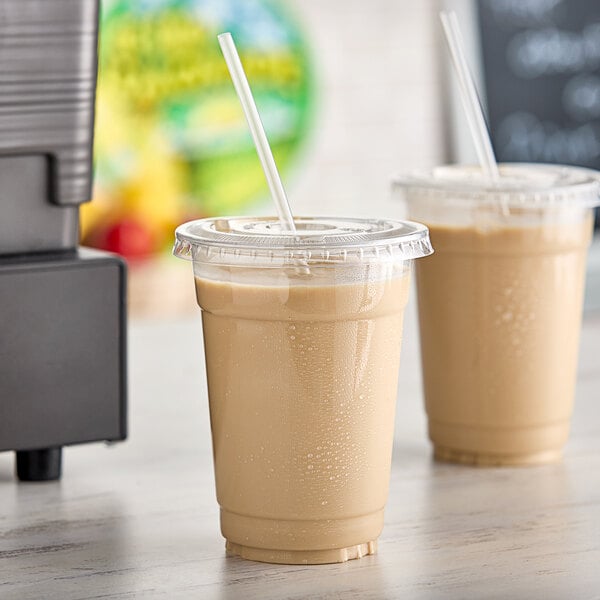 Two plastic cups of Fresh Blends caramel beverage with straws.