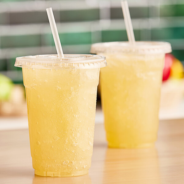 Two plastic cups with Fresh Blends Lemonade Base for FreshBlender Beverage System in them with white straws.