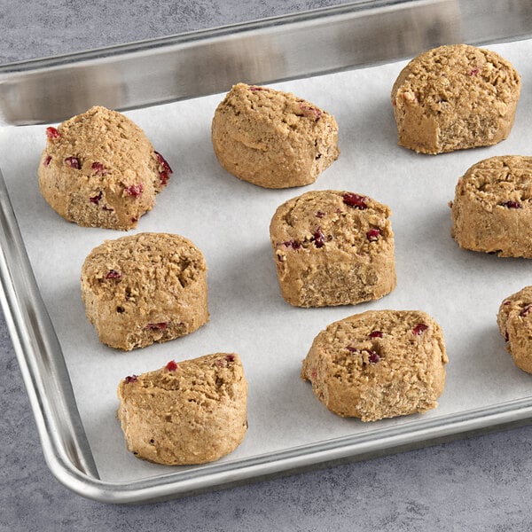 Sweet Loren's Gluten-Free Oatmeal Cranberry cookie dough on a baking sheet with six cookies.