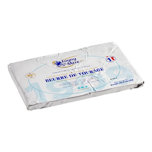 A package of Isigny Sainte-Mere butter sheets with blue and white labeling on a white surface.