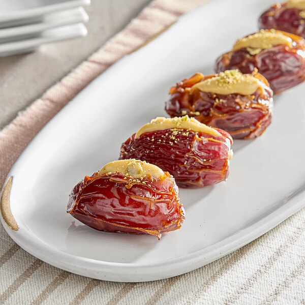 A plate of Whole Dried Medjool Dates on a table.