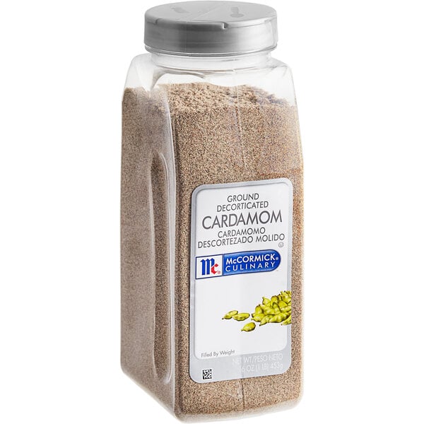 A plastic container of brown ground cardamom.