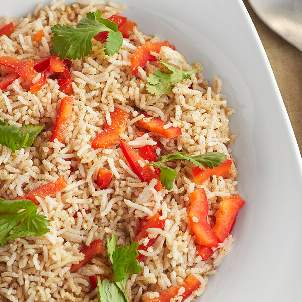A white plate with rice, peppers, and vegetables on it.