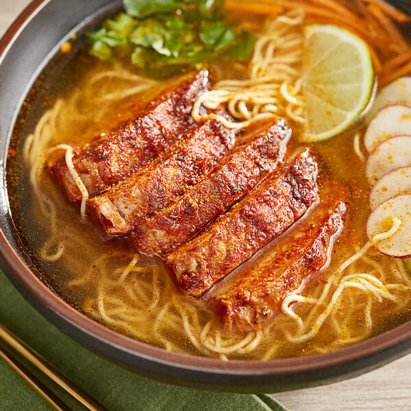 A bowl of soup with meat and noodles seasoned with McCormick Culinary Vietnamese Cajun Seasoning.