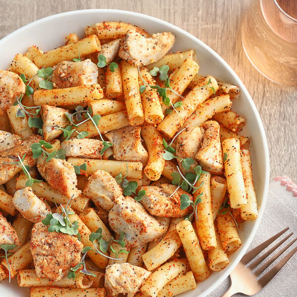 A plate of pasta with chicken and McCormick Culinary Salad Supreme Seasoning.