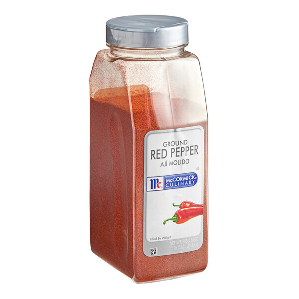 A plastic container of McCormick Culinary ground red pepper.