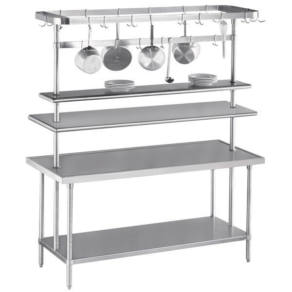 An Advance Tabco stainless steel pot rack holding two pots over a table.