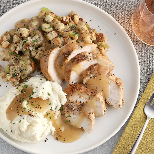 A plate of mashed potatoes, gravy, and chicken seasoned with McCormick Culinary Poultry Seasoning.