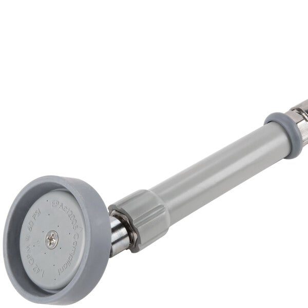 A close-up of a grey plastic handle with a round rubber disc and a screw.