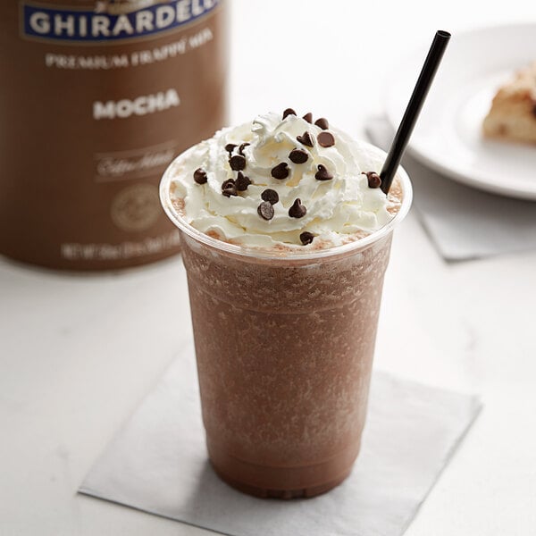 A close-up of a Ghirardelli Mocha Frappe with whipped cream and chocolate chips.