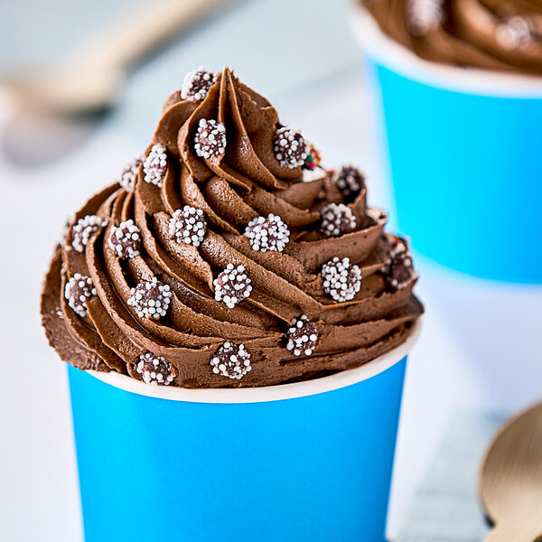 A chocolate frosted cupcake with white sprinkles.