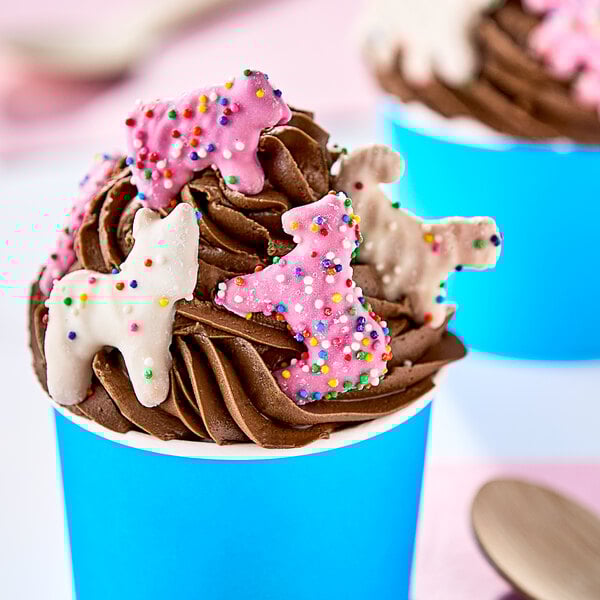 Yogurt-covered animal crackers with pink and white frosting.