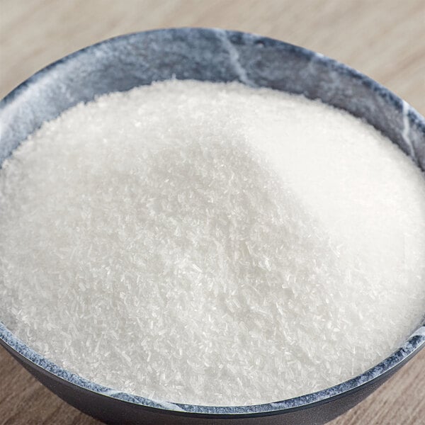 A bowl of McCormick Culinary MSG powder on a table.