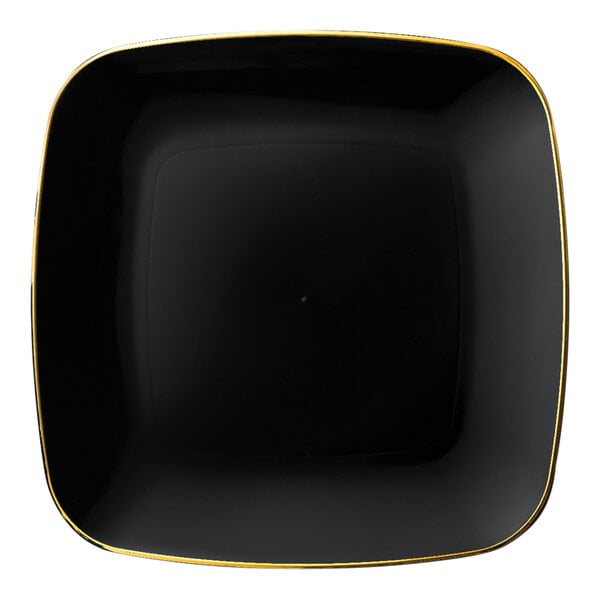 A black square plastic plate with a gold border.