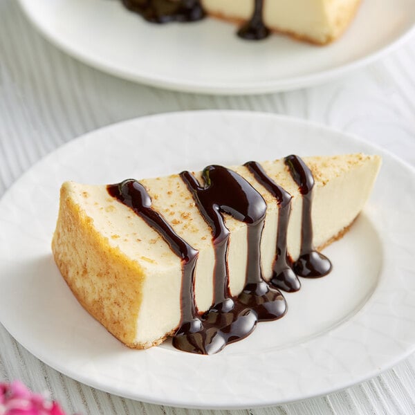 A slice of cheesecake with DaVinci Gourmet chocolate sauce on top.